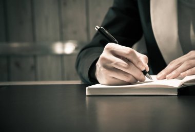 İş insanlar el üstünde defter yazma takım elbiseli yakın veya 