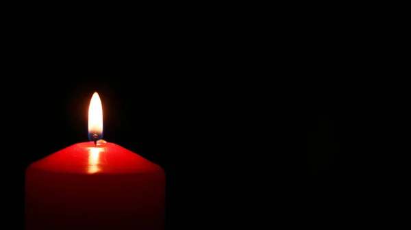 Red candle lit left — Stock Photo, Image