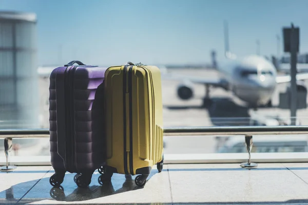 Two suitcases in airport departure lounge