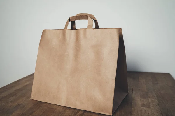 Brown paper package with handles — Stock Photo, Image