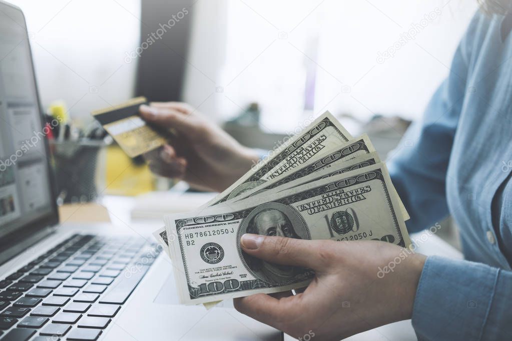 female hands counting US Dollar bills