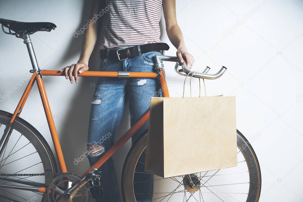 woman with vintage bike and paper package
