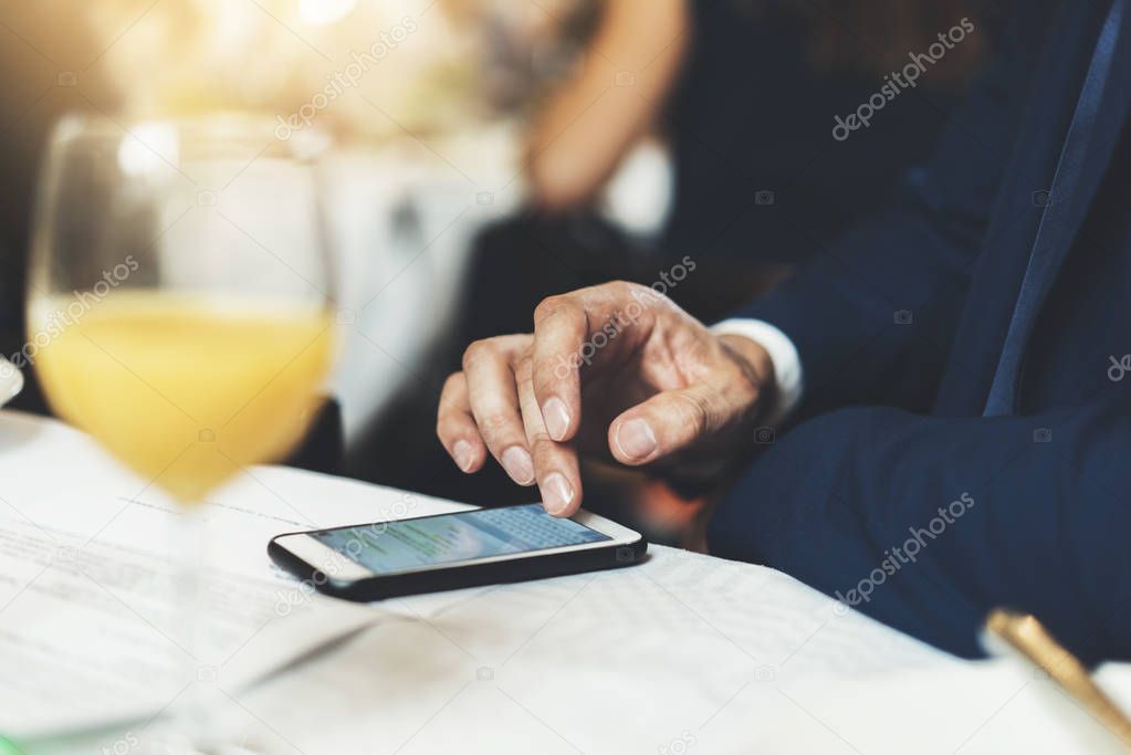 male writing sms via modern smartphone