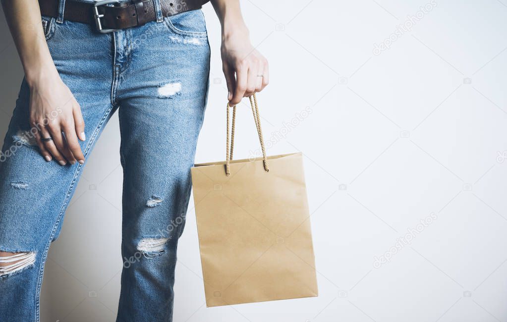 woman holding craft paper bag