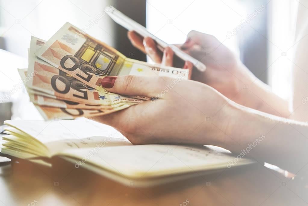 female hands counting euro bills