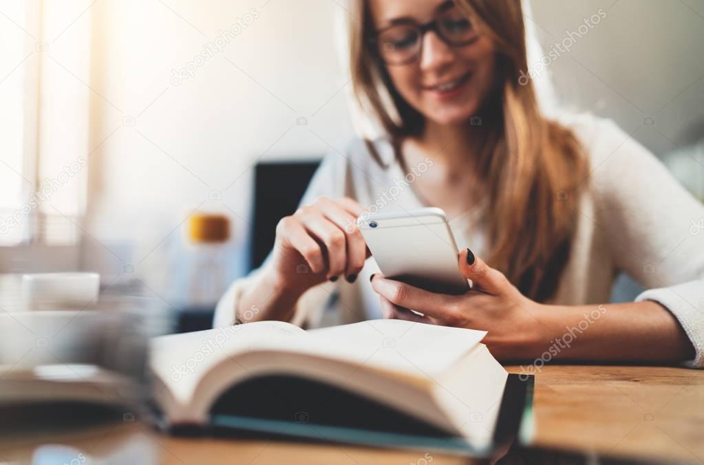 Girl using modern smartphone while working