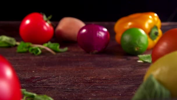 Two onions are moving toward each other on a table. Seasonal vegetables on the table, onion in the foreground. — Stock Video