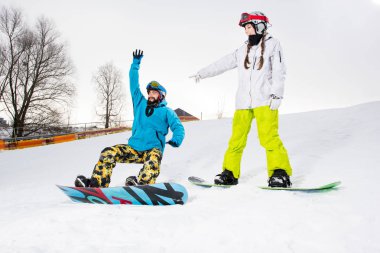 Young couple of snowboarders clipart