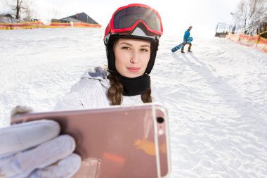 Snowboarder taking selfie clipart