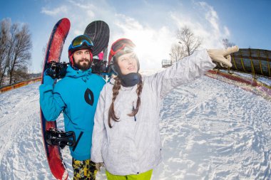 Man and woman with snowboards clipart