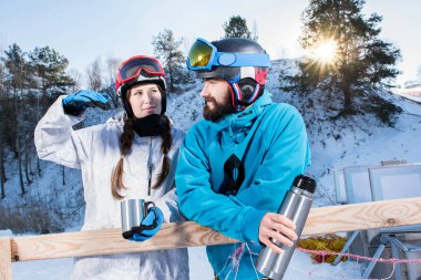 Snowboarders drinking tea  clipart