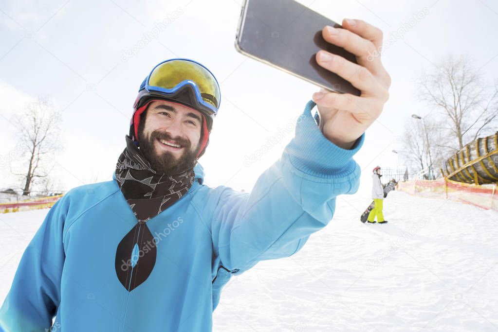 Snowboarder taking selfie