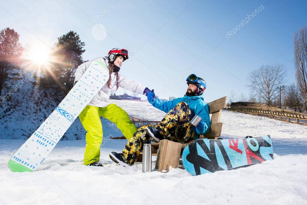 Young couple of snowboarders 