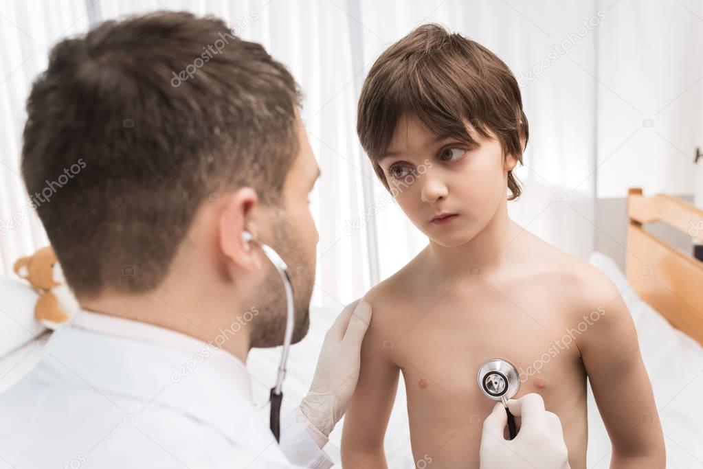 Doctor examining child patient 