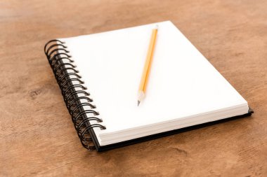Pencil and notebook on table clipart