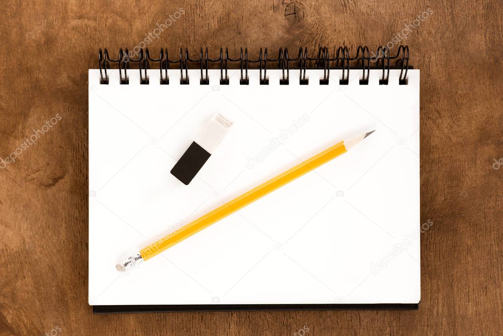 Pencil and notebook on table