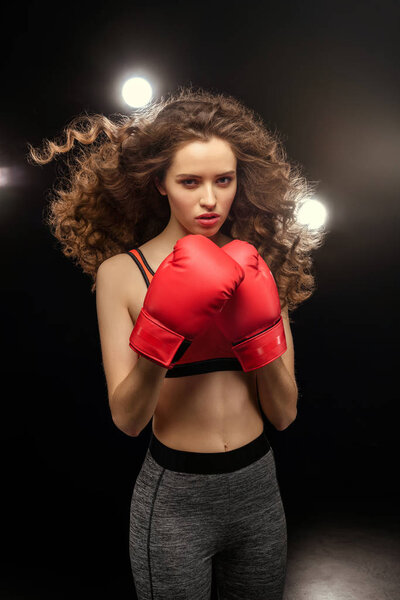 Young woman in boxing gloves 