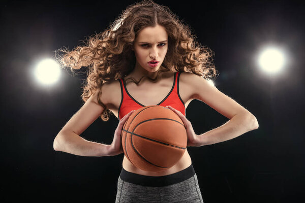 Sporty woman with basketball ball 