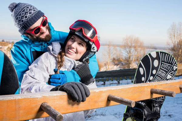Couple of snowboarders embracing — Stock Photo