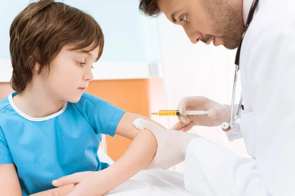 Médico fazendo injeção para menino — Fotografia de Stock