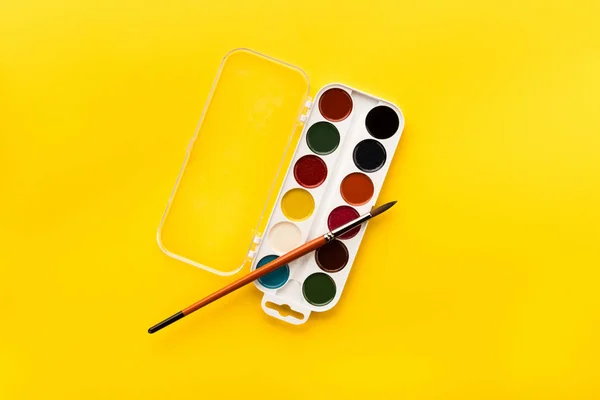Brush and paints on table — Stock Photo