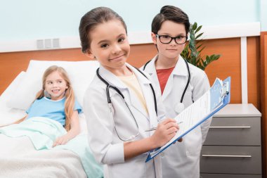 Kids playing doctors and patient   clipart