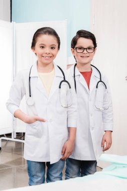 Kids playing doctors clipart