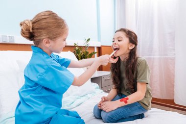 kids playing nurse and patient clipart