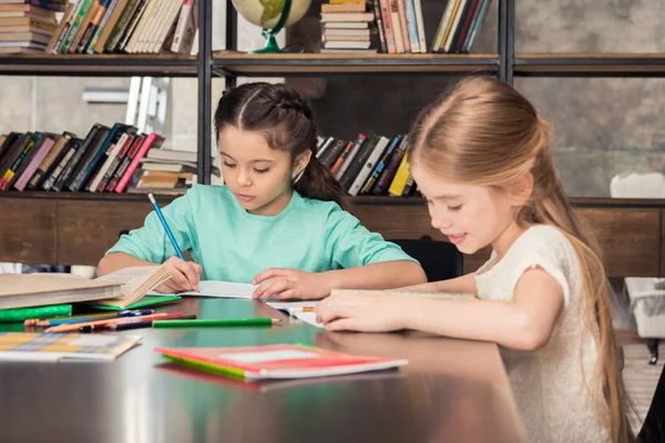 Schoolchildren studying together — Stock Photo, Image