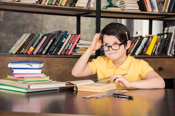 Schoolboy studying in library — Stock Photo, Image