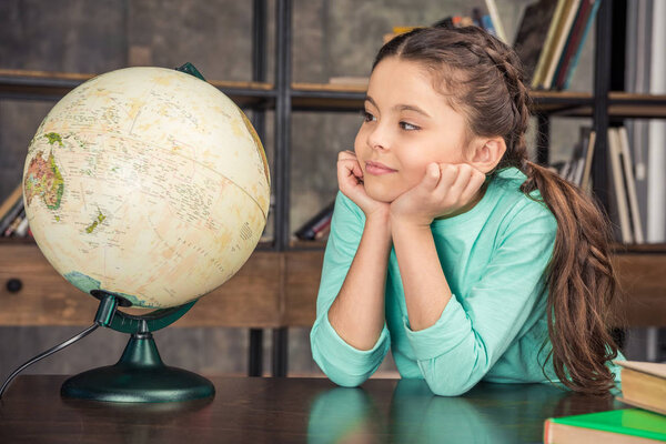 girl with globe in library