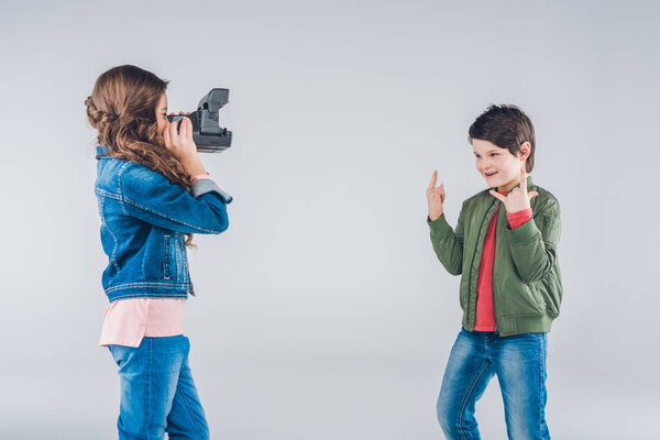 Girl taking pictures of boy