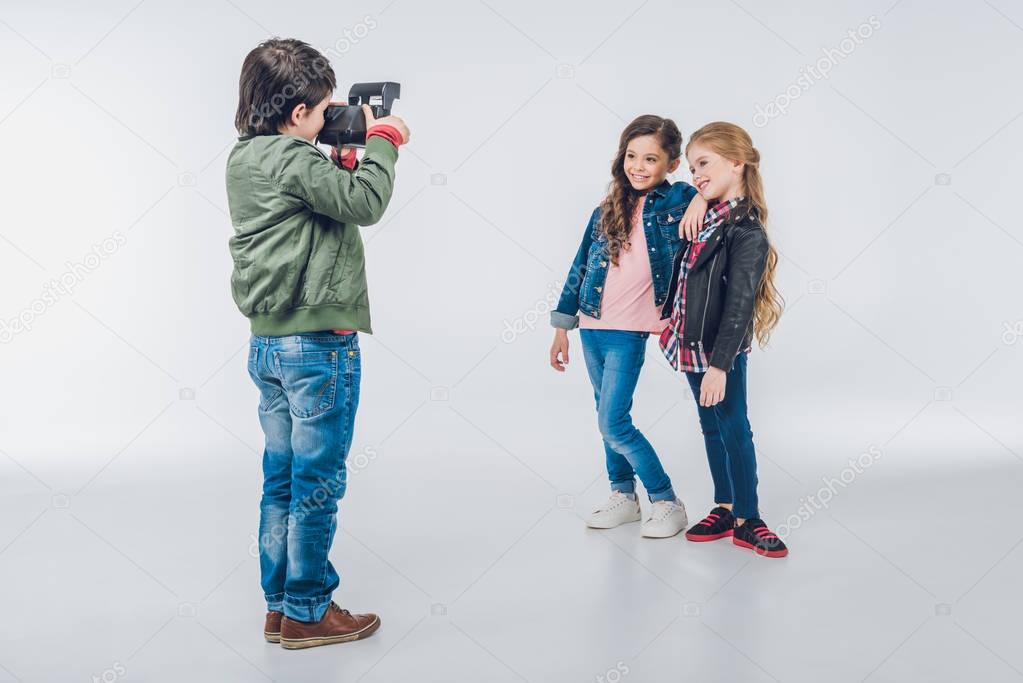 Boy photographing girls