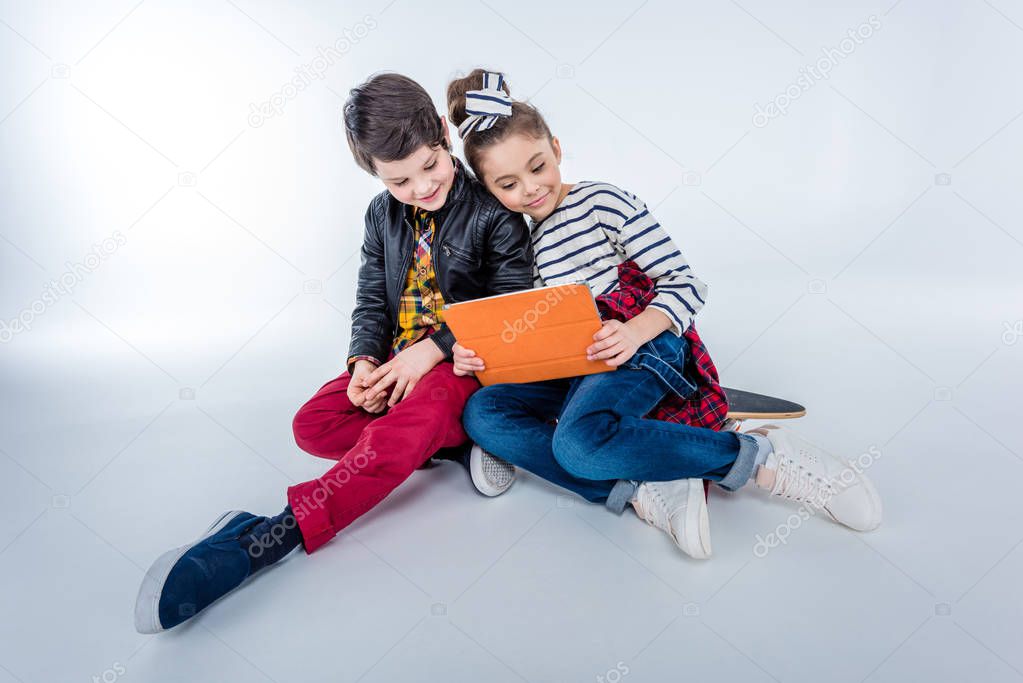 boy and girl using tablet