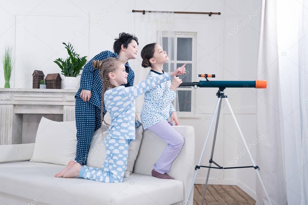 kids playing with telescope