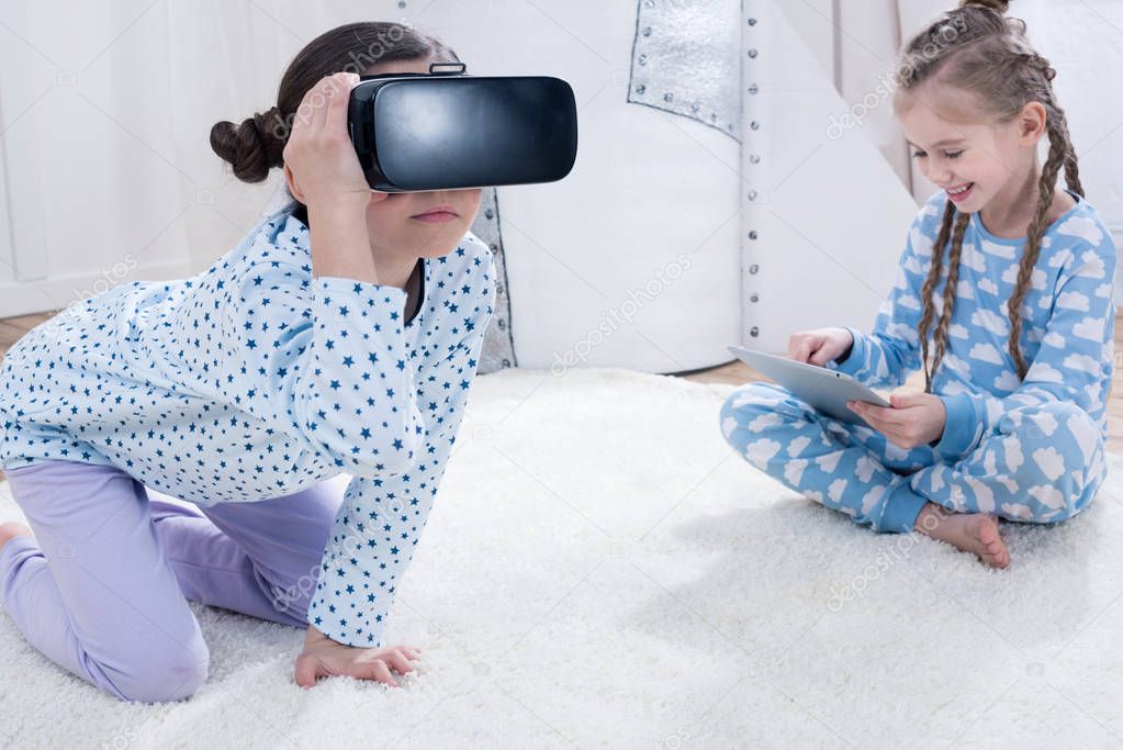 girls with VR and digital tablet  