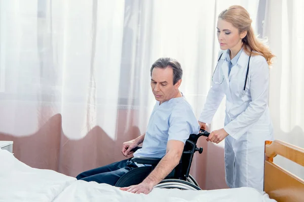 Elderly man sitting in wheelchair — Stock Photo, Image