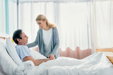wife visiting husband in hospital  clipart