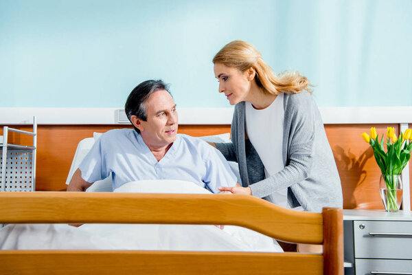 woman helping husband stand up