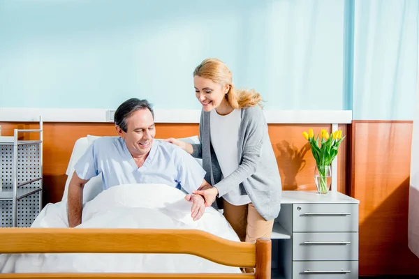 Woman helping husband stand up — Stock Photo, Image