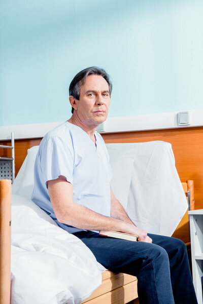 man sitting on hospital bed