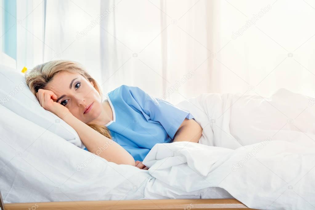 woman lying in hospital bed