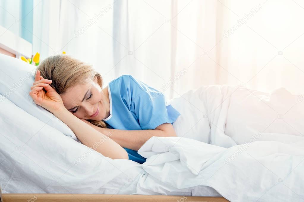 woman lying in hospital bed