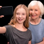 Grandmother and granddaughter taking selfie