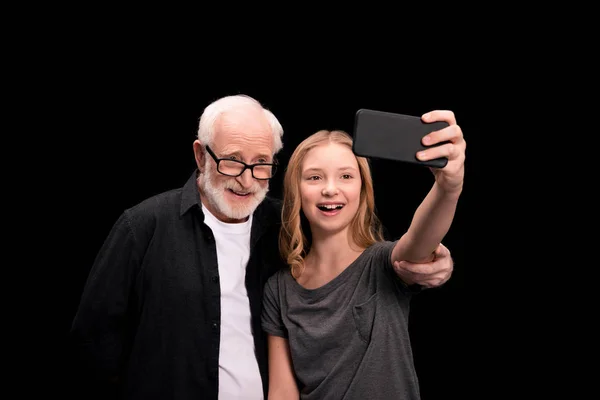 Grandfather and granddaughter taking selfie — Stock Photo, Image