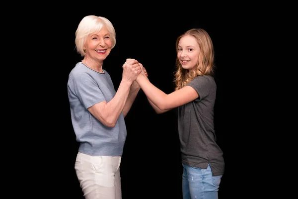 Grandmother and granddaughter holding hands — Free Stock Photo