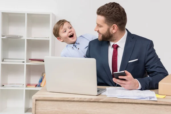 Naughty boy with his father businessman — Stock Photo, Image