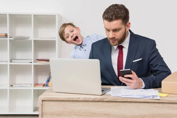 Naughty boy with his father businessman — Stock Photo, Image