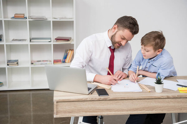 Businessman with son in office 