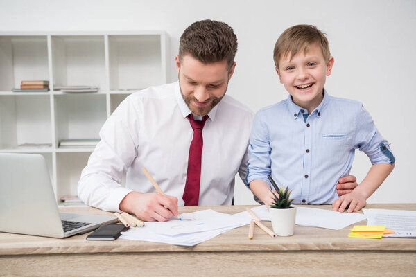 Businessman with son in office 